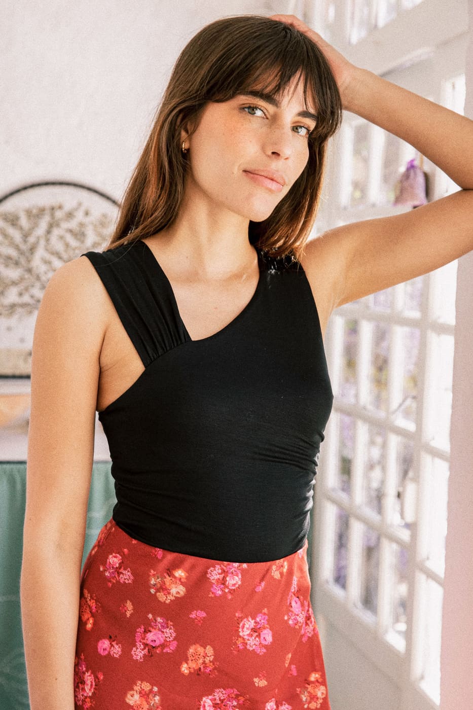 Body noir en jersey Tencel avec encolure asymétrique et bretelles drapées, fabriqué au Portugal